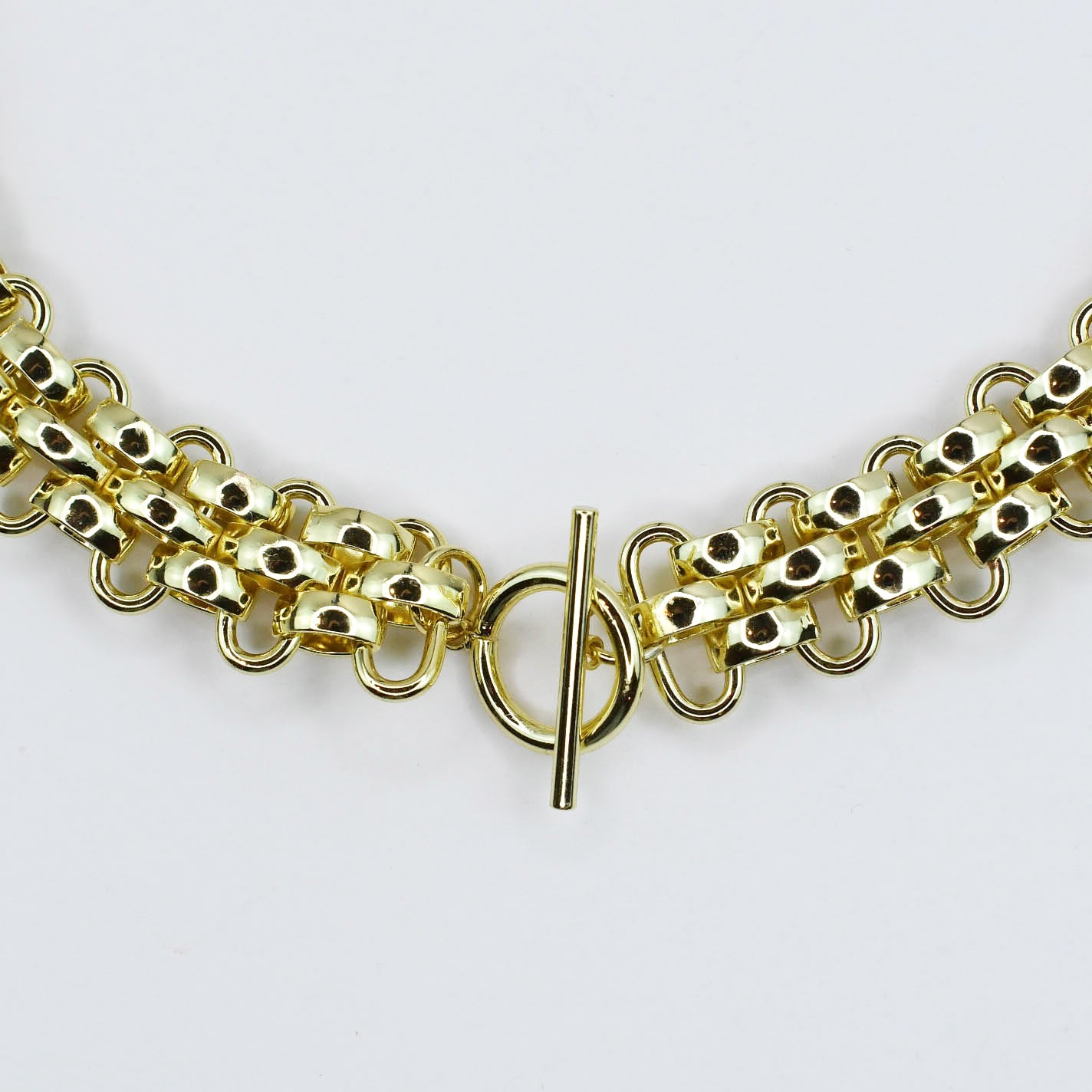 Dainty gold layered necklace, boutique wholesale jewelry, waterproof gold necklace, hypoallergenic and tarnish free statement accessory featuring a gold chain necklace with textured links and a front toggle clasp