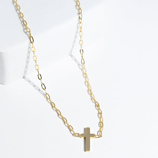 Dainty gold layered necklace with a smooth cross pendant, trendy statement accessory for wholesale jewelry for women’s boutiques and boutique wholesale jewelry, waterproof necklaces that are hypoallergenic and tarnish free